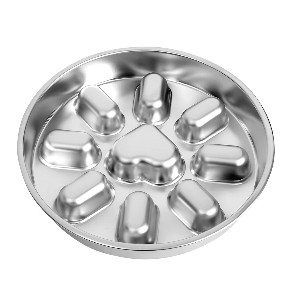 Stainless steel slow feeder dog bowl with a circular design, featuring a raised heart-shaped obstacle in the center and eight raised ridges around it.