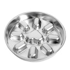 Stainless steel slow feeder dog bowl with a circular design, featuring a raised heart-shaped obstacle in the center and eight raised ridges around it.